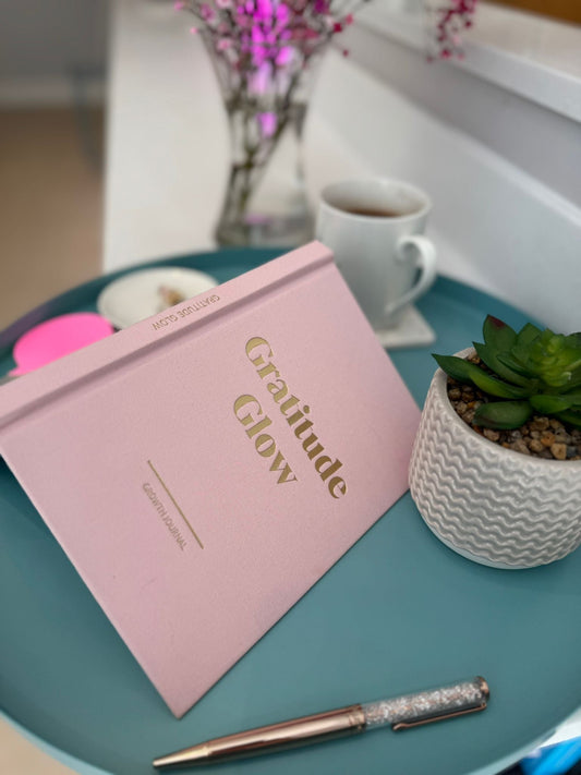 Image of Gratitude Glow Journal on a tray next to coffee and plant